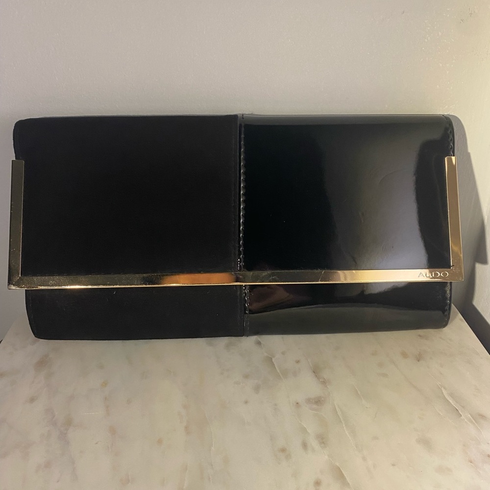 Aldo black clutch with gold chain strap.